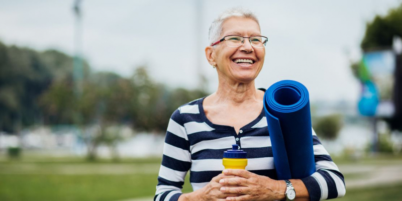 woman holding exercise mat, exercise and cancer